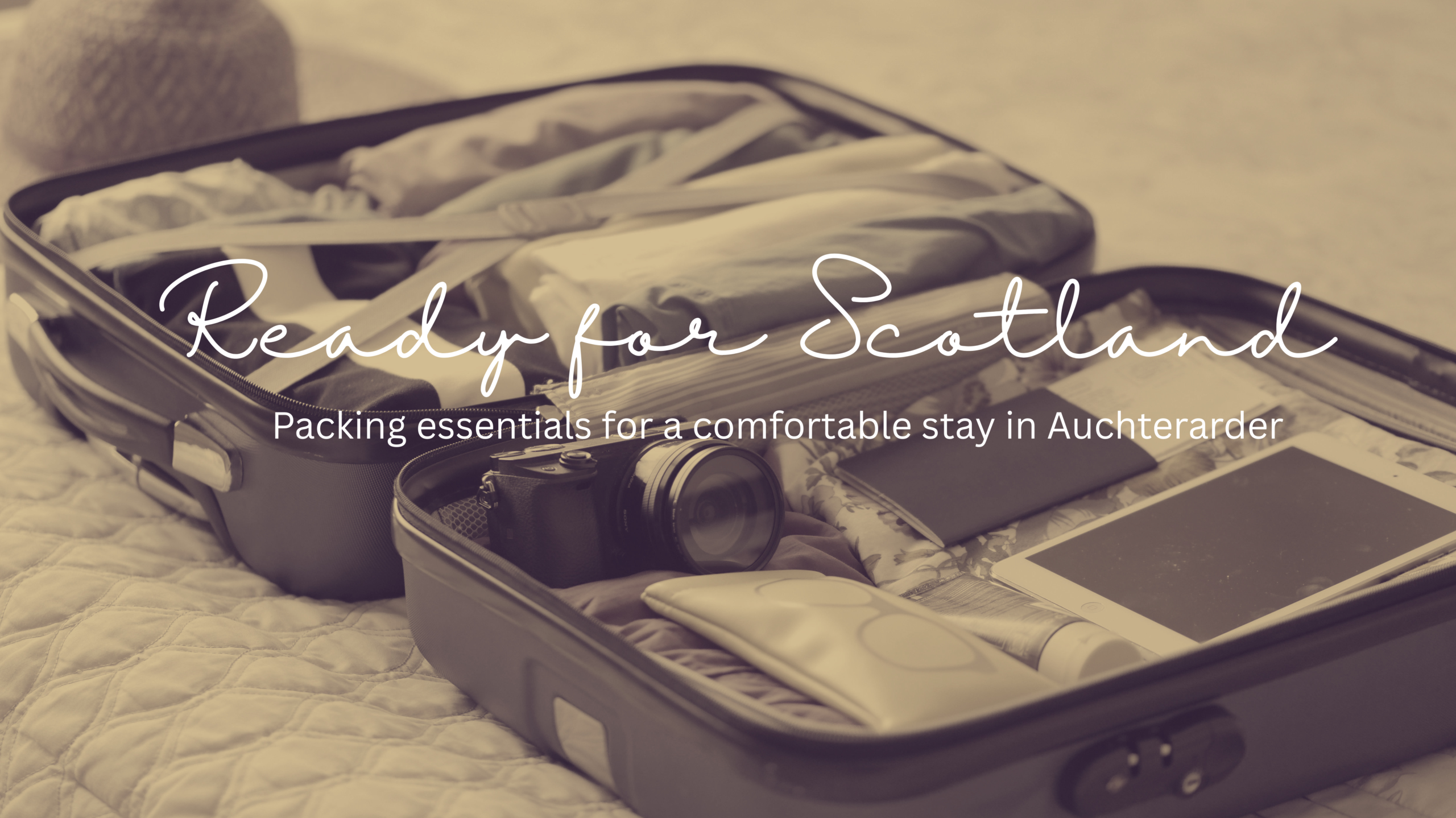 Open suitcase with travel essentials for a Scottish getaway in Auchterarder
